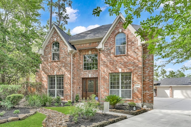 7 Newland Ct, The Woodlands, TX 77382 - traditional home with brick siding, roof with shingles, driveway, and a garage