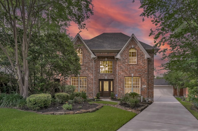 7 Newland Ct, The Woodlands, TX 77382 - view of front of property with brick siding, a lawn, and a shingled roof