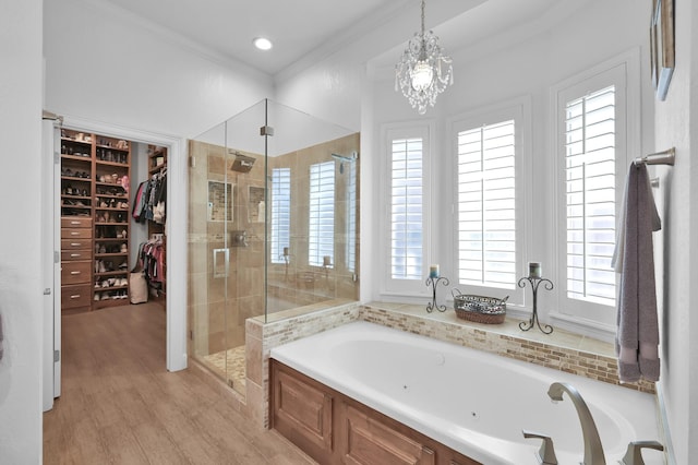 7 Newland Ct, The Woodlands, TX 77382 - bathroom featuring a tub with jets, a stall shower, healthy amount of natural light, wood finished floors, and crown molding