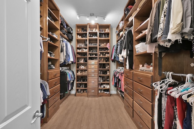 7 Newland Ct, The Woodlands, TX 77382 - walk in closet with light wood-style flooring