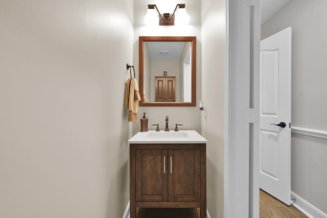 7 Newland Ct, The Woodlands, TX 77382 - bathroom featuring vanity, wood finished floors, and baseboards