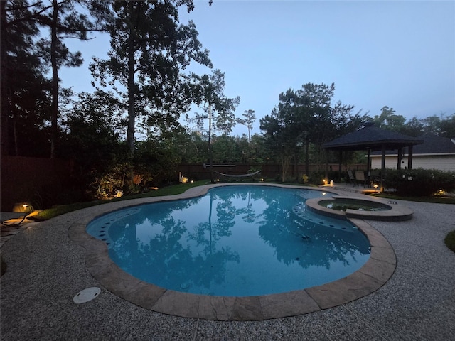 7 Newland Ct, The Woodlands, TX 77382 - view of pool with a fenced backyard, a pool with connected hot tub, a gazebo, and a patio