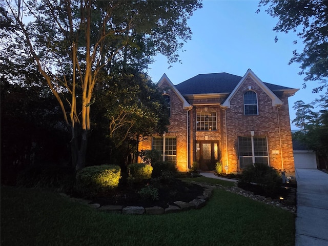 7 Newland Ct, The Woodlands, TX 77382 - view of front of home with brick siding and a front yard