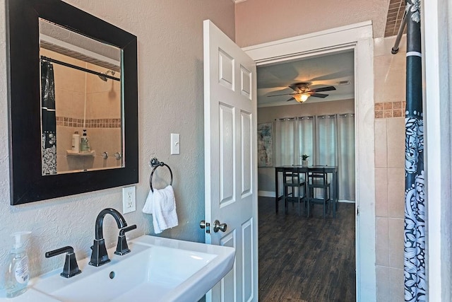 5213 Claremont St, Houston, TX 77023 - full bath with a sink, ceiling fan, a textured wall, and wood finished floors