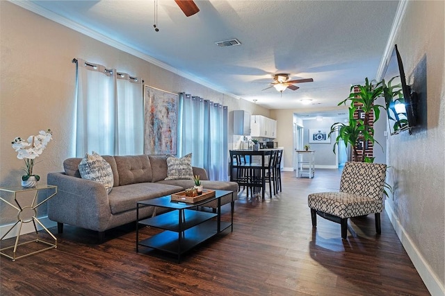 5213 Claremont St, Houston, TX 77023 - living room featuring a ceiling fan, crown molding, dark wood finished floors, a textured wall, and baseboards