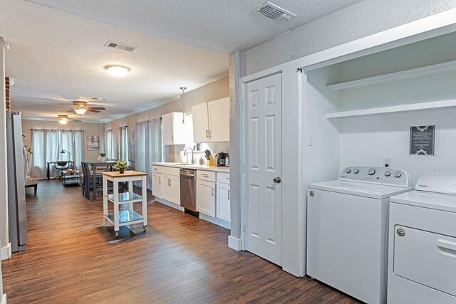 5213 Claremont St, Houston, TX 77023 - laundry area with washing machine and clothes dryer, dark wood-style flooring, a ceiling fan, and a textured ceiling
