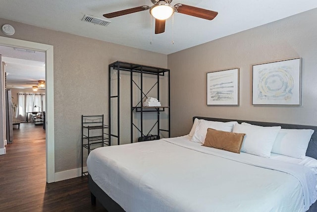 5213 Claremont St, Houston, TX 77023 - bedroom featuring dark wood-type flooring, baseboards, a textured wall, and ceiling fan