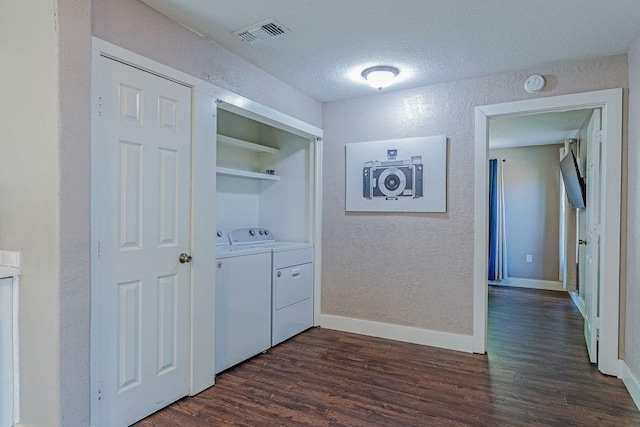 5213 Claremont St, Houston, TX 77023 - hall with washer and clothes dryer, a textured wall, dark wood-style flooring, baseboards, and a textured ceiling