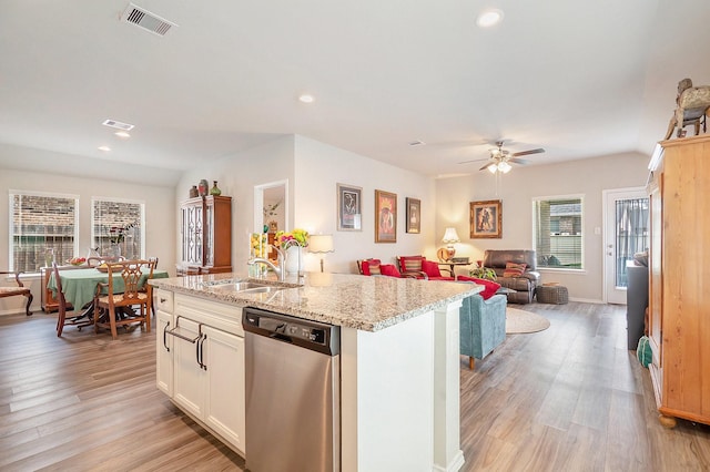 9521 Mountain Maple Pl, Conroe, TX 77385 - kitchen featuring stainless steel dishwasher, a sink, a ceiling fan, open floor plan, and light wood-style flooring