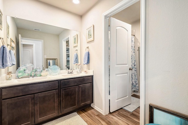 9521 Mountain Maple Pl, Conroe, TX 77385 - full bath with wood finished floors, double vanity, baseboards, a shower with shower curtain, and recessed lighting