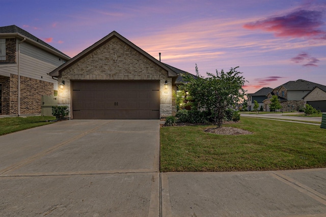 9521 Mountain Maple Pl, Conroe, TX 77385 - view of front of home with concrete driveway, a front yard, a garage, and stone siding