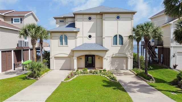 1554 Windsong Way, Tiki Island, TX 77554 - view of front of house with stucco siding, concrete driveway, an attached garage, and a front lawn