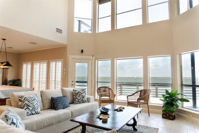 1554 Windsong Way, Tiki Island, TX 77554 - living room with a towering ceiling, crown molding, a water view, and light tile patterned floors