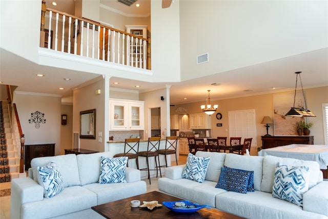 1554 Windsong Way, Tiki Island, TX 77554 - living area featuring stairway, recessed lighting, a towering ceiling, crown molding, and decorative columns