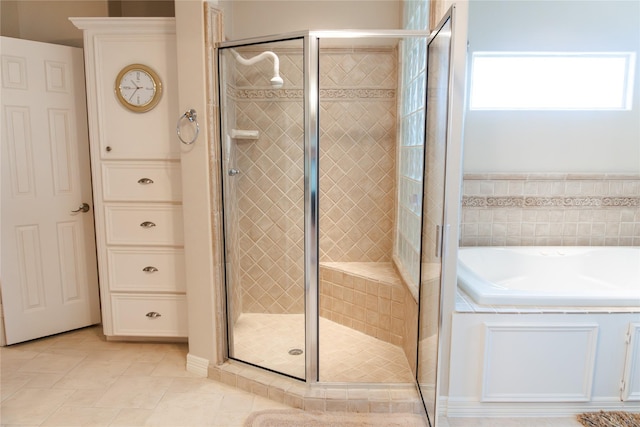 1554 Windsong Way, Tiki Island, TX 77554 - full bathroom featuring a bath, a stall shower, and tile patterned flooring