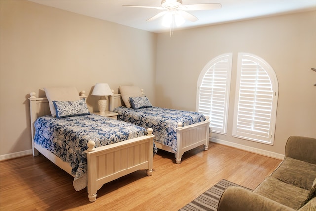 1554 Windsong Way, Tiki Island, TX 77554 - bedroom featuring baseboards, light wood-style flooring, and a ceiling fan