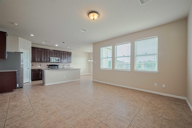 3722 Glover Meadows Ln, Houston, TX 77047 - kitchen with appliances with stainless steel finishes, light tile patterned floors, open floor plan, light countertops, and tasteful backsplash