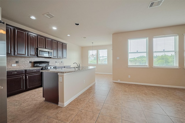 3722 Glover Meadows Ln, Houston, TX 77047 - kitchen featuring appliances with stainless steel finishes, decorative backsplash, light tile patterned flooring, a sink, and recessed lighting