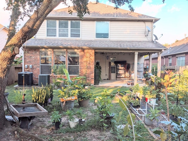 6318 Alpine Trail Ln, Katy, TX 77494 - back of property with cooling unit, a patio, and brick siding