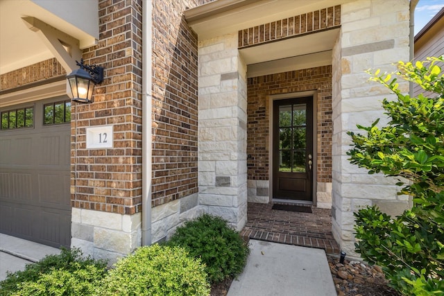 12 Centennial Ridge Pl, Magnolia, TX 77354 - doorway to property featuring a garage, brick siding, and stone siding