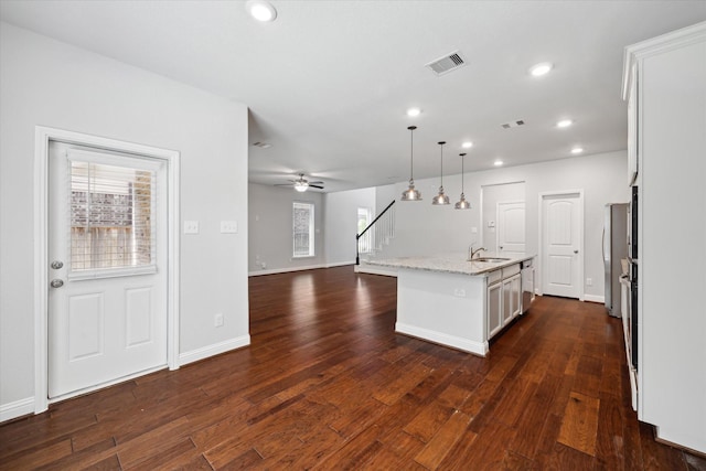 12 Centennial Ridge Pl, Magnolia, TX 77354 - kitchen with a sink, a center island with sink, white cabinetry, dark wood finished floors, and recessed lighting