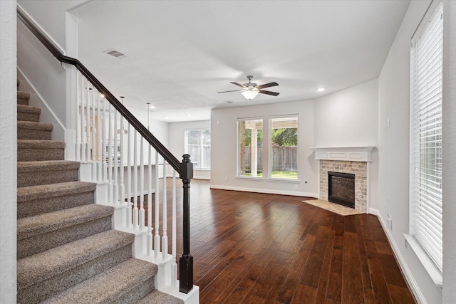 12 Centennial Ridge Pl, Magnolia, TX 77354 - unfurnished living room with dark wood-style flooring, a ceiling fan, stairs, baseboards, and recessed lighting