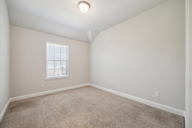 12 Centennial Ridge Pl, Magnolia, TX 77354 - spare room featuring carpet, baseboards, and vaulted ceiling