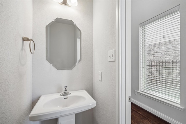 12 Centennial Ridge Pl, Magnolia, TX 77354 - bathroom featuring a sink, wood finished floors, and baseboards