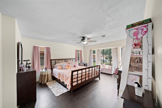 19527 Enchanted Spring Dr, Spring, TX 77388 - bedroom featuring dark wood finished floors, ceiling fan, and a textured ceiling