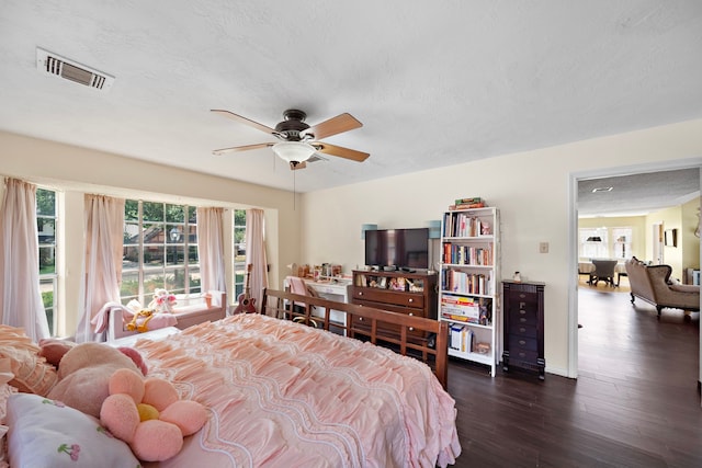 19527 Enchanted Spring Dr, Spring, TX 77388 - bedroom with dark wood-style flooring, multiple windows, a textured ceiling, and a ceiling fan