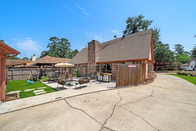 19527 Enchanted Spring Dr, Spring, TX 77388 - rear view of property featuring a gazebo, a patio, a chimney, brick siding, and roof with shingles