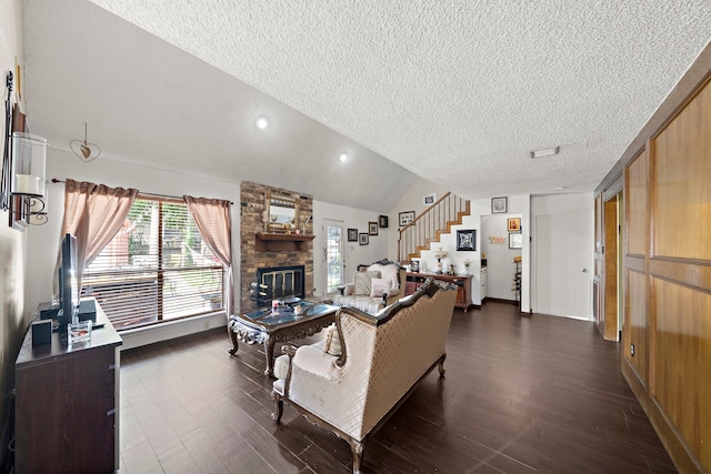 19527 Enchanted Spring Dr, Spring, TX 77388 - living room with a textured ceiling, stairs, dark wood-style flooring, a brick fireplace, and lofted ceiling