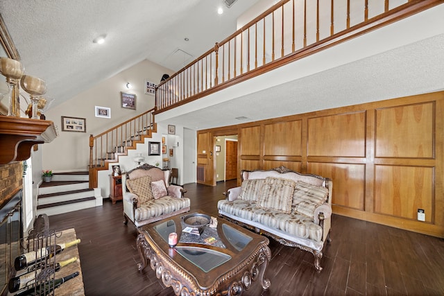 19527 Enchanted Spring Dr, Spring, TX 77388 - living area featuring high vaulted ceiling, dark wood-type flooring, stairs, a textured ceiling, and baseboards