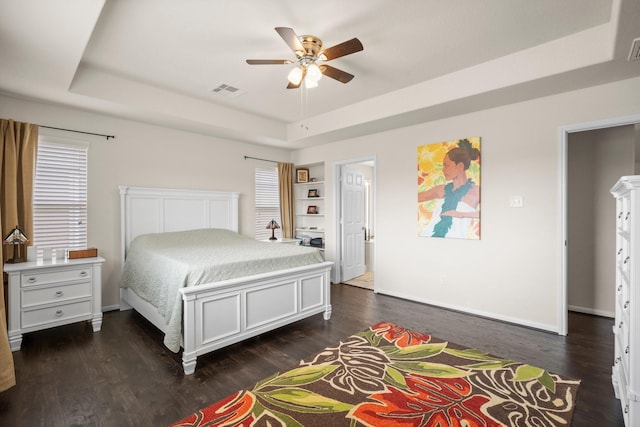 10606 Chestnut Pathway, Tomball, TX 77375 - bedroom with a tray ceiling, dark wood-style flooring, baseboards, and a ceiling fan