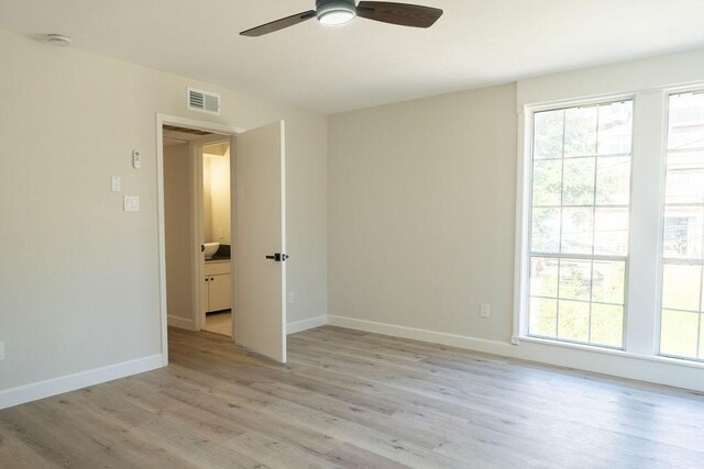 2243 W Alabama St Unit 10, Houston, TX 77098 - spare room featuring a ceiling fan, light wood finished floors, and baseboards