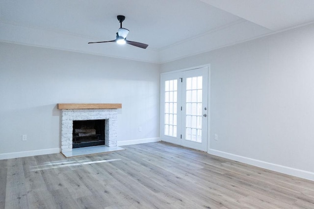 2243 W Alabama St Unit 10, Houston, TX 77098 - unfurnished living room featuring wood finished floors, baseboards, a ceiling fan, a fireplace, and ornamental molding