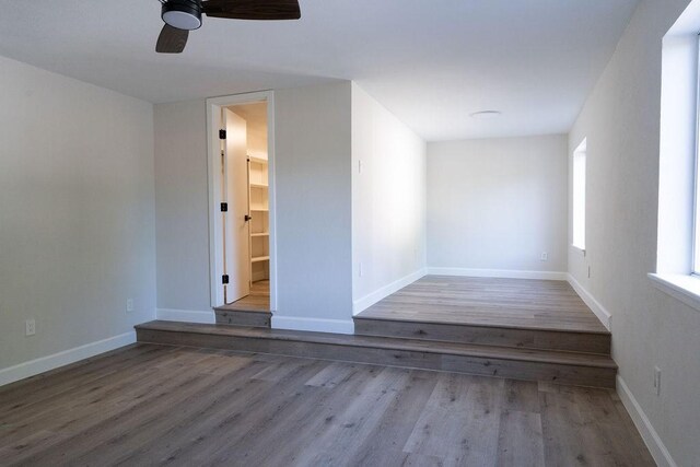 2243 W Alabama St Unit 10, Houston, TX 77098 - spare room featuring wood finished floors, ceiling fan, and baseboards