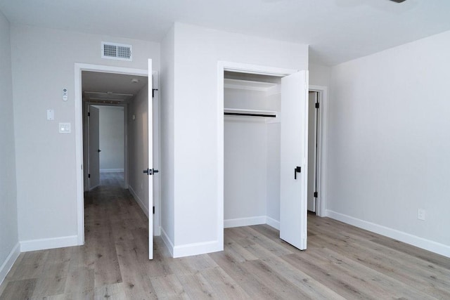 2243 W Alabama St Unit 10, Houston, TX 77098 - unfurnished bedroom with light wood-type flooring, a closet, and baseboards