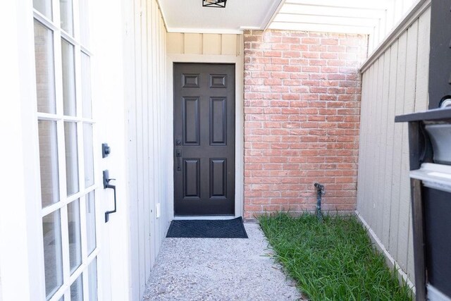 2243 W Alabama St Unit 10, Houston, TX 77098 - property entrance featuring brick siding and board and batten siding