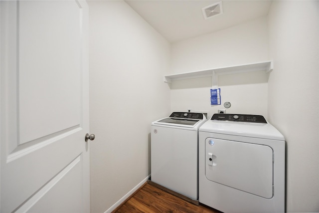 10127 Clearwick St, Houston, TX 77034 - laundry area with washer and dryer, dark wood-style flooring, and baseboards