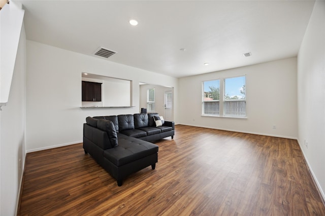 10127 Clearwick St, Houston, TX 77034 - living room with dark wood-style flooring, baseboards, and recessed lighting