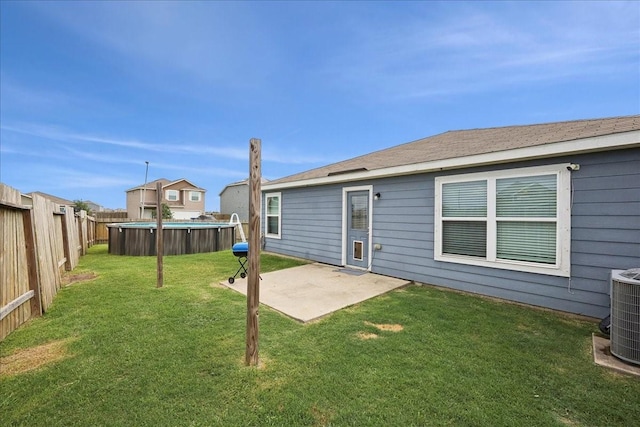 6011 Treasure Cove Rd, Cove, TX 77523 - back of property with central air condition unit and a patio