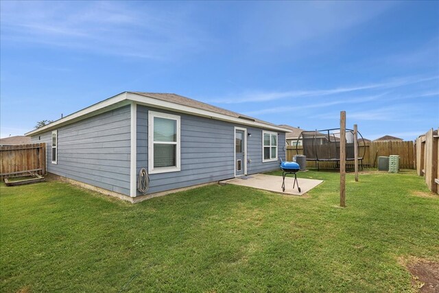 6011 Treasure Cove Rd, Cove, TX 77523 - rear view of property featuring a patio area and a trampoline