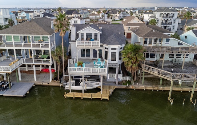 1827 Port O Call St, Tiki Island, TX 77554 - dock featuring a balcony, a residential view, and a water view