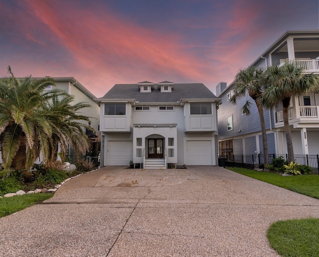 1827 Port O Call St, Tiki Island, TX 77554 - view of front facade with a garage, concrete driveway, and french doors