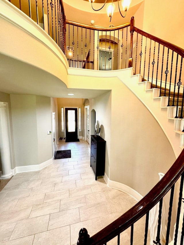 7739 Augusta Creek Ct, Spring, TX 77389 - foyer entrance with stairs, a towering ceiling, baseboards, and a chandelier