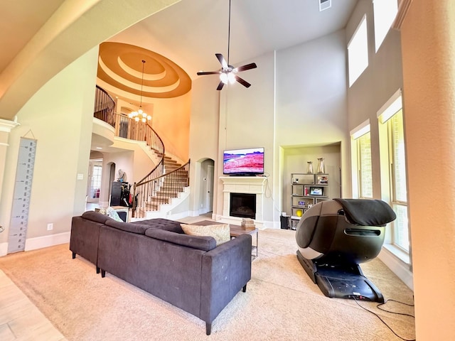 7739 Augusta Creek Ct, Spring, TX 77389 - living area with a high ceiling, plenty of natural light, stairway, arched walkways, and a fireplace
