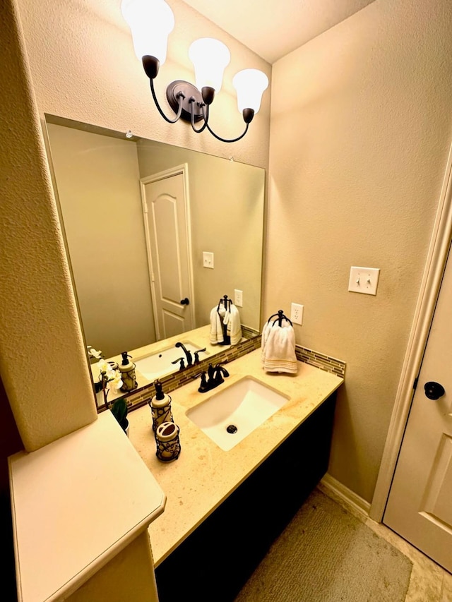 7739 Augusta Creek Ct, Spring, TX 77389 - bathroom with vanity, a chandelier, and a textured wall