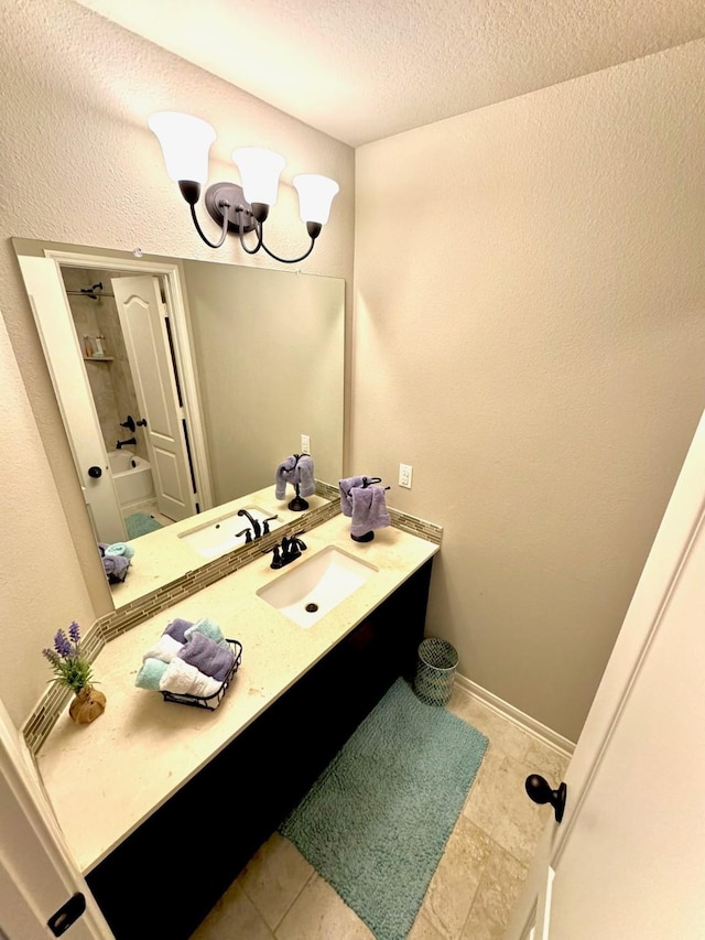 7739 Augusta Creek Ct, Spring, TX 77389 - bathroom with vanity, a textured ceiling, a chandelier, tile patterned flooring, and bathing tub / shower combination