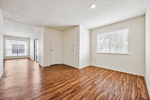 6701 Sands Point Dr Unit 129, Houston, TX 77074 - spare room featuring a textured ceiling, baseboards, and wood finished floors